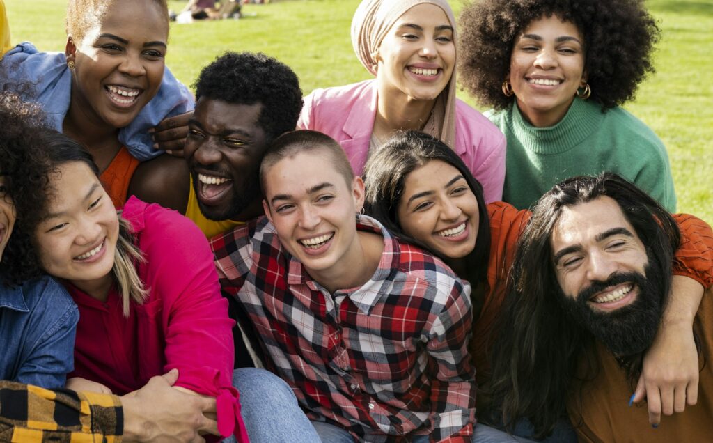 group of multiracial people having fun outdoors. diverse people hugging and enjoying the holidays.